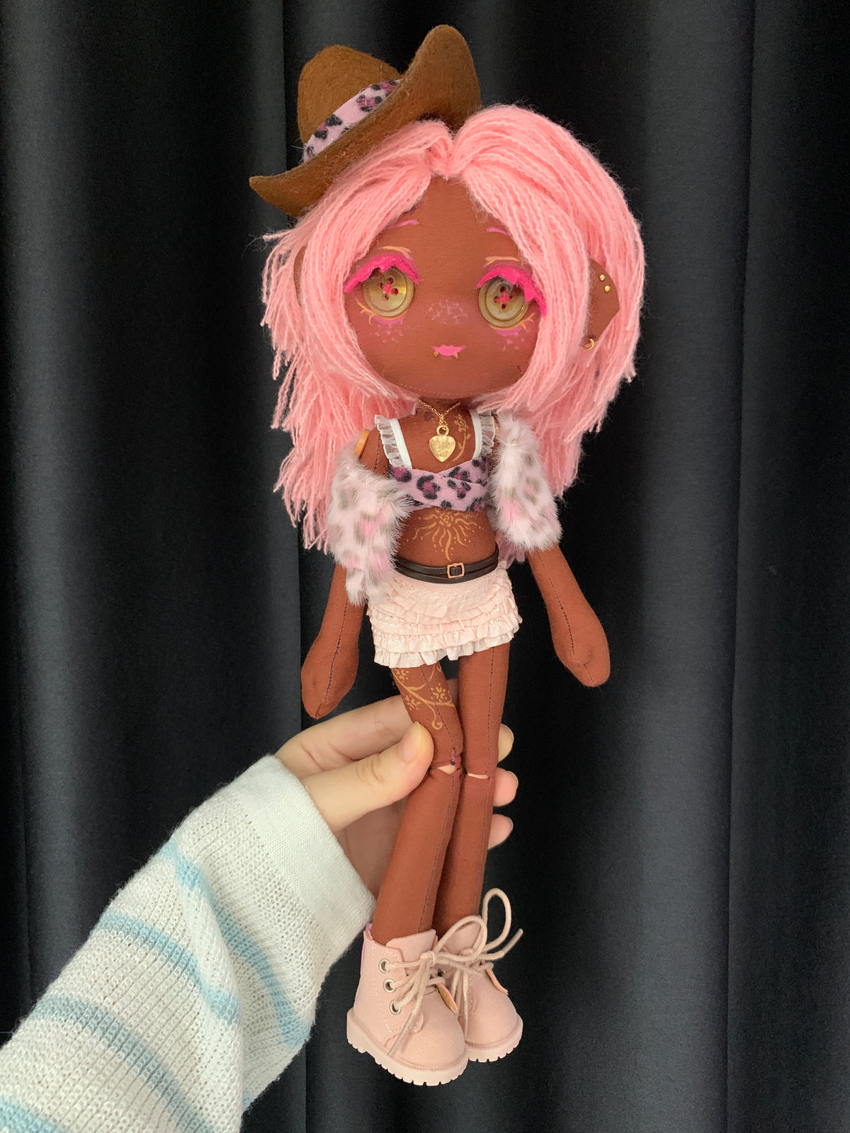 Full-length view of Coco Berry OOAK handmade cloth art doll with pink yarn hair, brown cowboy hat, button eyes, ruffled skirt, and pink boots.